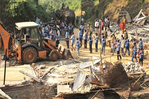 District Administration carrying out an eviction drive with deploying excavators with elephants at Amchang Forest Reserve at Botahghuli in Guwahati on 27-11-17. Reportedly District administration told that four teams have been constituted for the drive and each team will comprise officers from the administration, police, forest department, power department, medical and SDRF (fire & emergency) to carry out eviction from all sides. Forest department sources said over 3,000 personnel have been mobilised for the operation besides some ten elephants and excavators. Pix by UB Photos